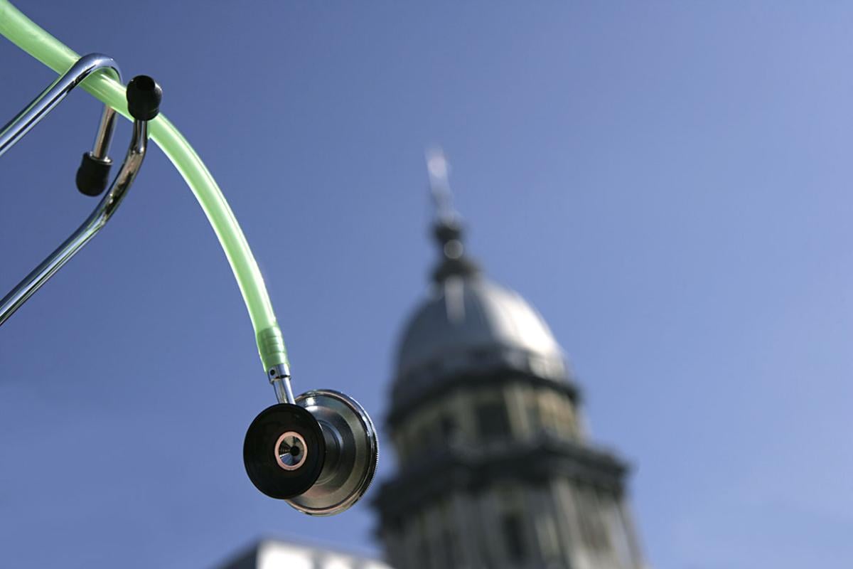 Stethoscope in front of a stately building